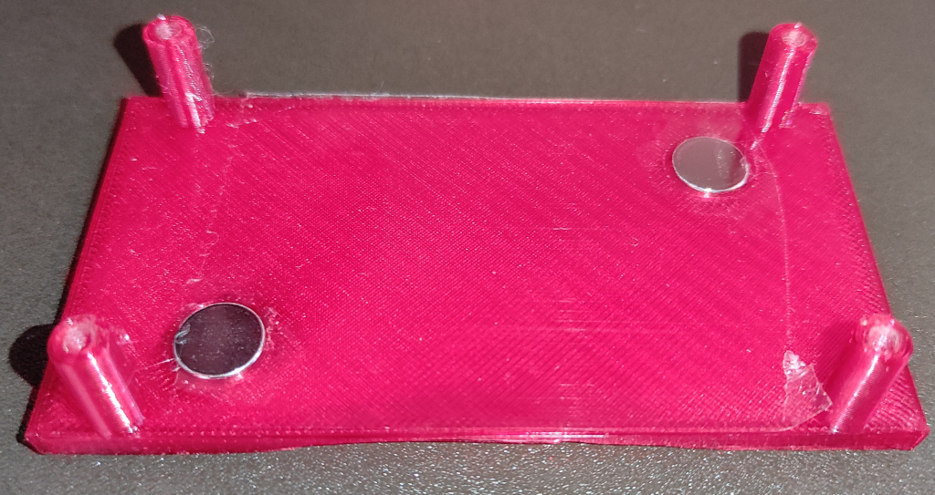 Picture shows 3D printed holder for ULX3S - it has to magnets pushed in the case. It is simple 60mm x 40mm x 2mm cube with 4 cylinders on edges that are 20mm high